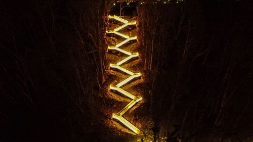 Close-up of illuminated lamp at night