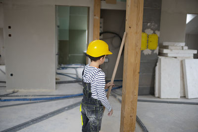 Rear view of man standing against wall