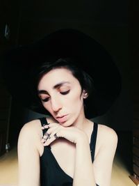 Close-up of young woman wearing hat