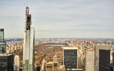 High angle view of buildings against cloudy sky