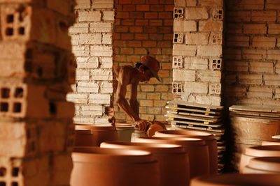 Low angle view of man standing against wall