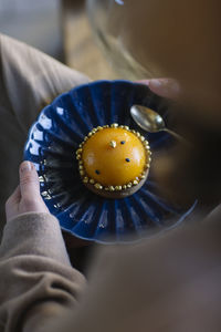 Woman holding plate with peach tartlet