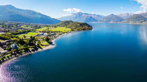 Scenic view of lake by mountains against sky