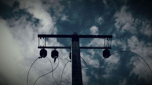 Low angle view of street light against cloudy sky