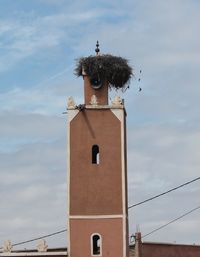 Low angle view of bell tower against sky