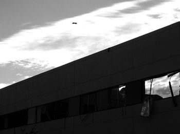 Low angle view of building against cloudy sky