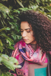 Close-up of young woman by plants