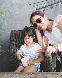 Woman with daughter showing peace sign