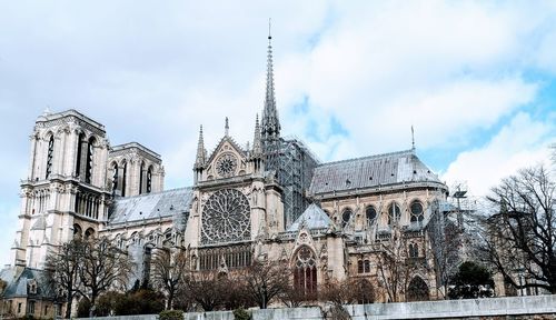 Low angle view of cathedral notre dame de paris against sky