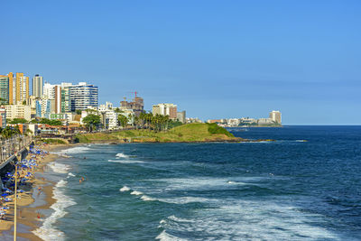 Top view of praia da barra in salvador, bahia on a sunny summer day with the surrounding buildings.