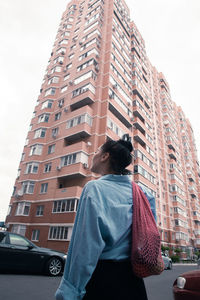 Two young women with shopping bags walking in the city