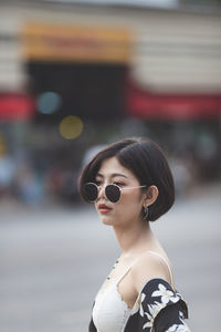 Woman wearing sunglasses in city