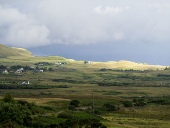 Scenic view of green landscape against sky