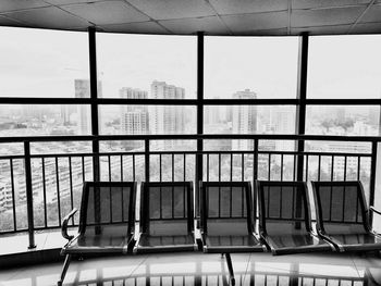 Metallic structure against sky seen through window