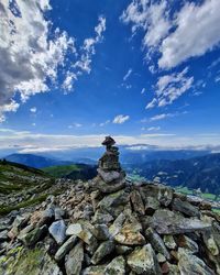 Stack of rocks on mountain against sky