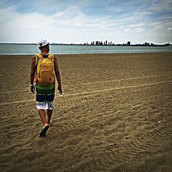 Rear view of woman standing on beach