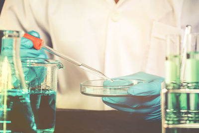 Midsection of scientist working in laboratory