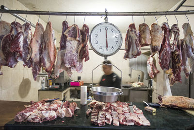 Meat and weigh scale hanging in a butcher stall