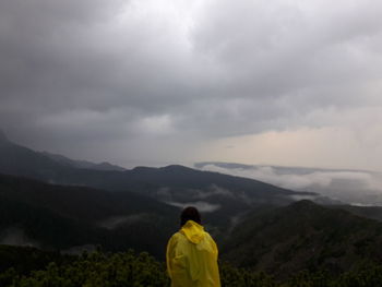Rear view of woman standing on landscape
