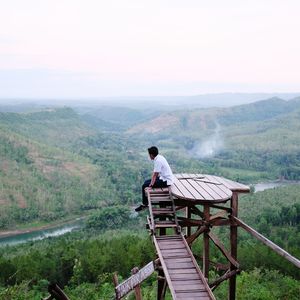 Man standing on mountain against clear sky