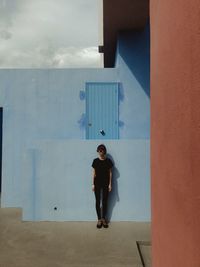 Full length of man standing against wall in building