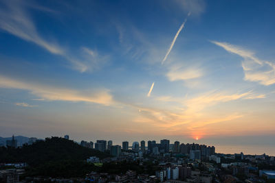 Scenic view of buildings against sky during sunset