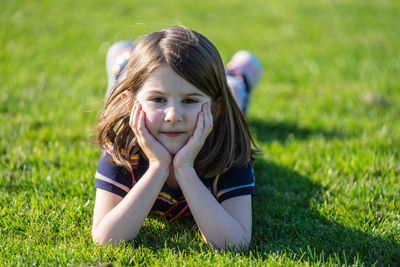 Portrait of cute girl standing on field