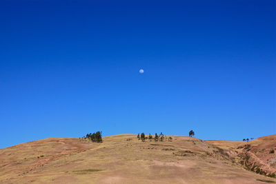 Low angle view of mountain against clear blue sky