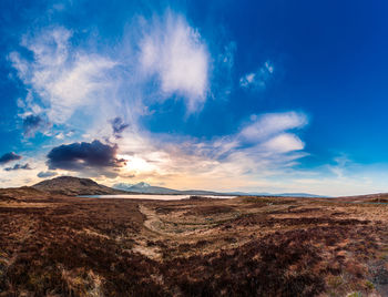 Scenic view of arid landscape against sky