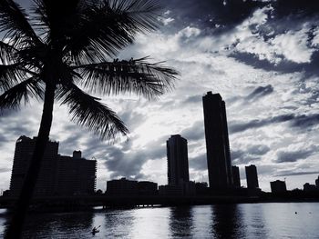 City by river against sky