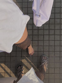 Low section of woman standing on tiled floor