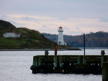 Lighthouse against cloudy sky