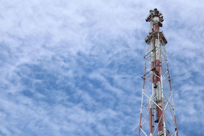 Low angle view of communications tower against sky