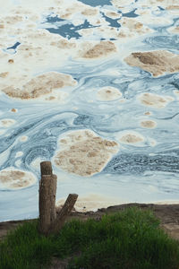 High angle view of wooden posts on beach