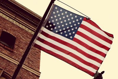 Low angle view of american flag against sky