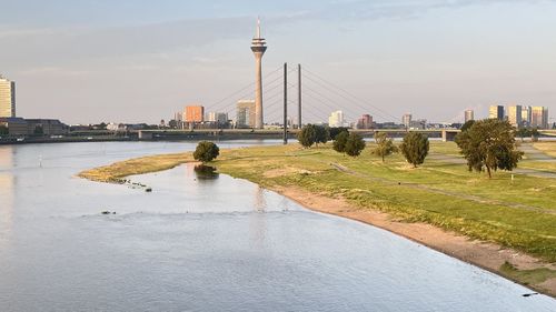 Bridge over river with city in background