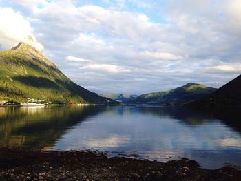 Scenic view of lake and mountains against sky