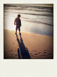 Full length of woman standing on shore