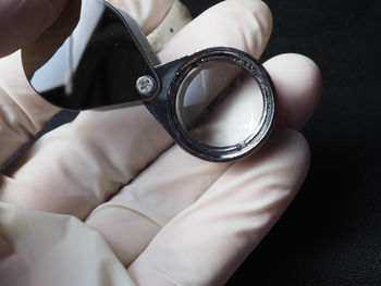 High angle view of human hand holding eyeglasses