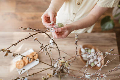 Midsection of woman holding plant