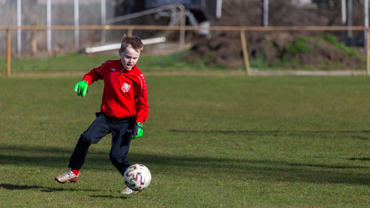 FULL LENGTH OF BOY PLAYING WITH BALL