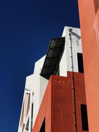 Low angle view of modern building against clear blue sky