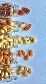 Directly above view of dried fruits jar over white background