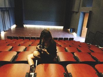 High angle view of woman sitting on chair at home