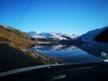 Scenic view of snowcapped mountains against clear blue sky