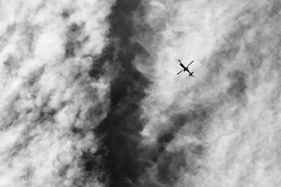 Low angle view of airplane flying in sky