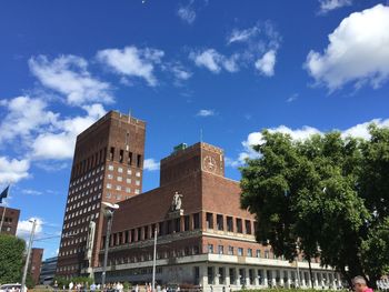 Low angle view of buildings against blue sky