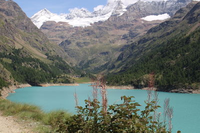 Scenic view of lake and mountains against sky