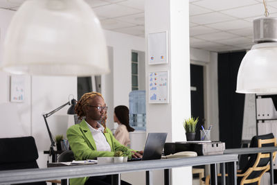 Side view of business colleagues working in office