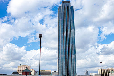 Low angle view of buildings against cloudy sky